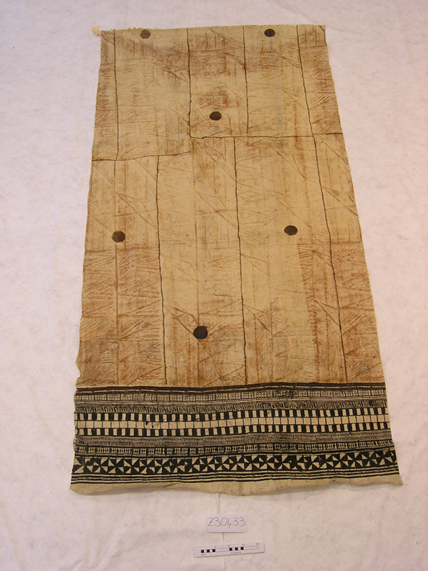Barkcloth with intricate black patterned detailing on the near edge.