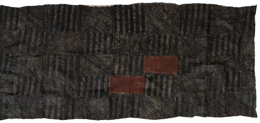 Red-brown, white and black barkcloth. Good shape. Mainly black and white, "snakeskin" type design with two smallish rectangles of plain red-brown colour towards one end.