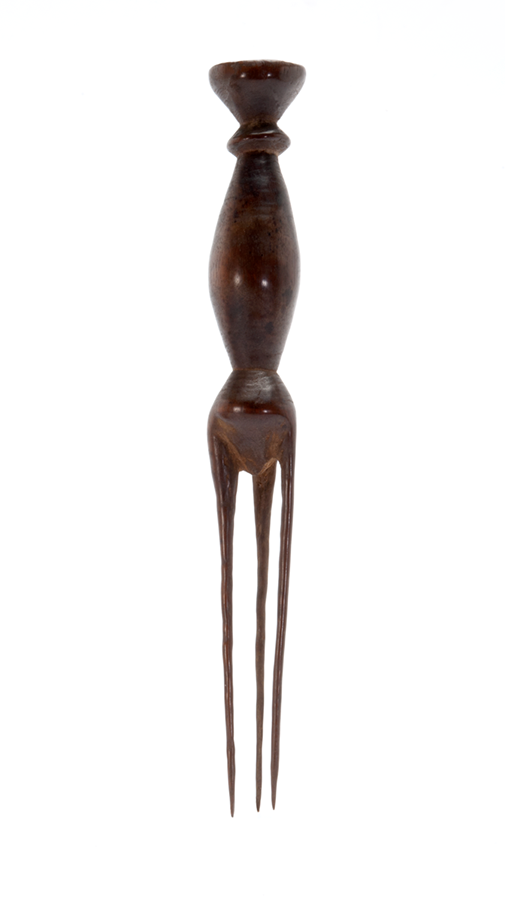 Dark wooden fork with three prongs and a cylindrical handle with tapering ends, in an hourglass shape.