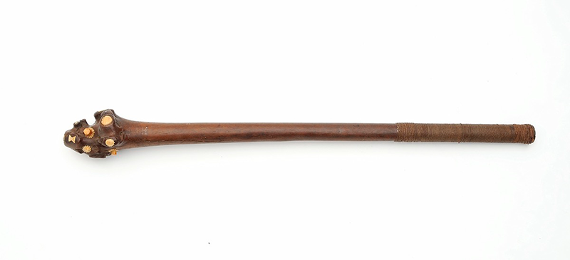Mid-dark brown wooden club with a rounded head, ornamented with ivory.