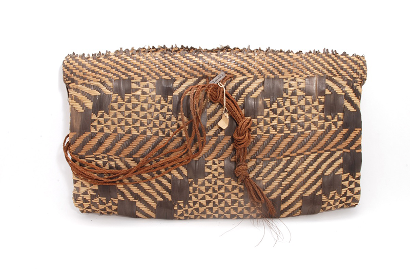 Flat rectangular satchel made from natural, black-dyed pandanus leaf, with geometric motifs from bottom to top.