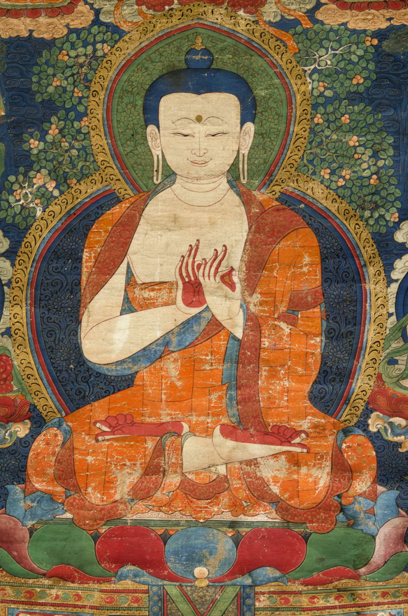 The Buddha wears a patchwork saffron robe and is seated in the diamond position.