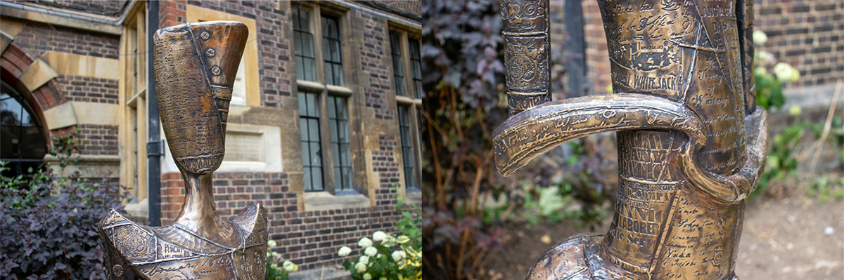 Two side by side detail photographs of the sculpture. The head (left) has a script panel, with the carved word 'MAORI' visible at the bottom. The arms and body (right) have mostly script and writing across them, which look like they come from a newspaper.