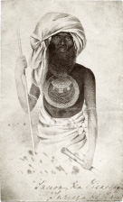 Sepia tone engraving of a man with a headscarf and large beard, wearing a breastplate and carrying a spear.