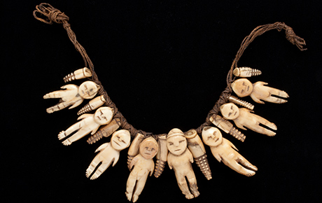 Necklace of eight ivory figures, interspersed with smaller decorative 'teeth' type figures.