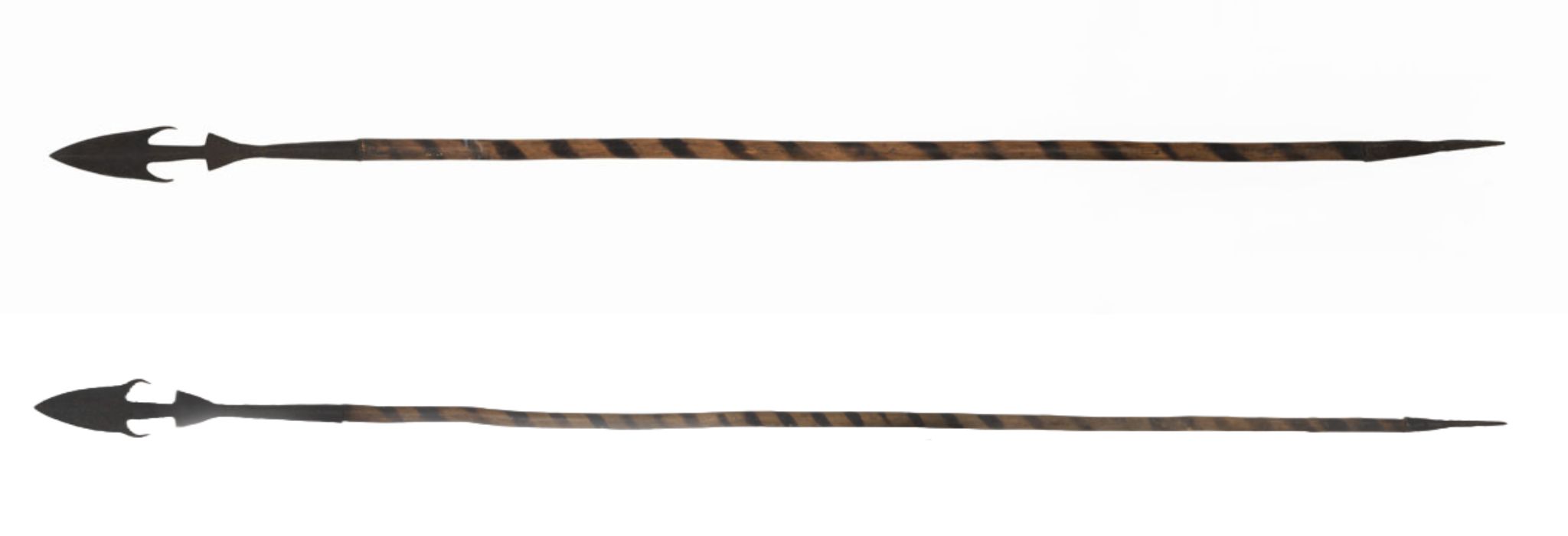 Two spears with triangular blades which have slightly convex edges and two barbs. The wooden shafts are decorated with spiral bands of dark colour.