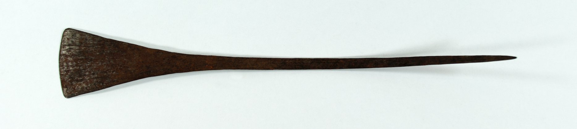  An iron hairpin with a triangular head that tapers down into a point.
