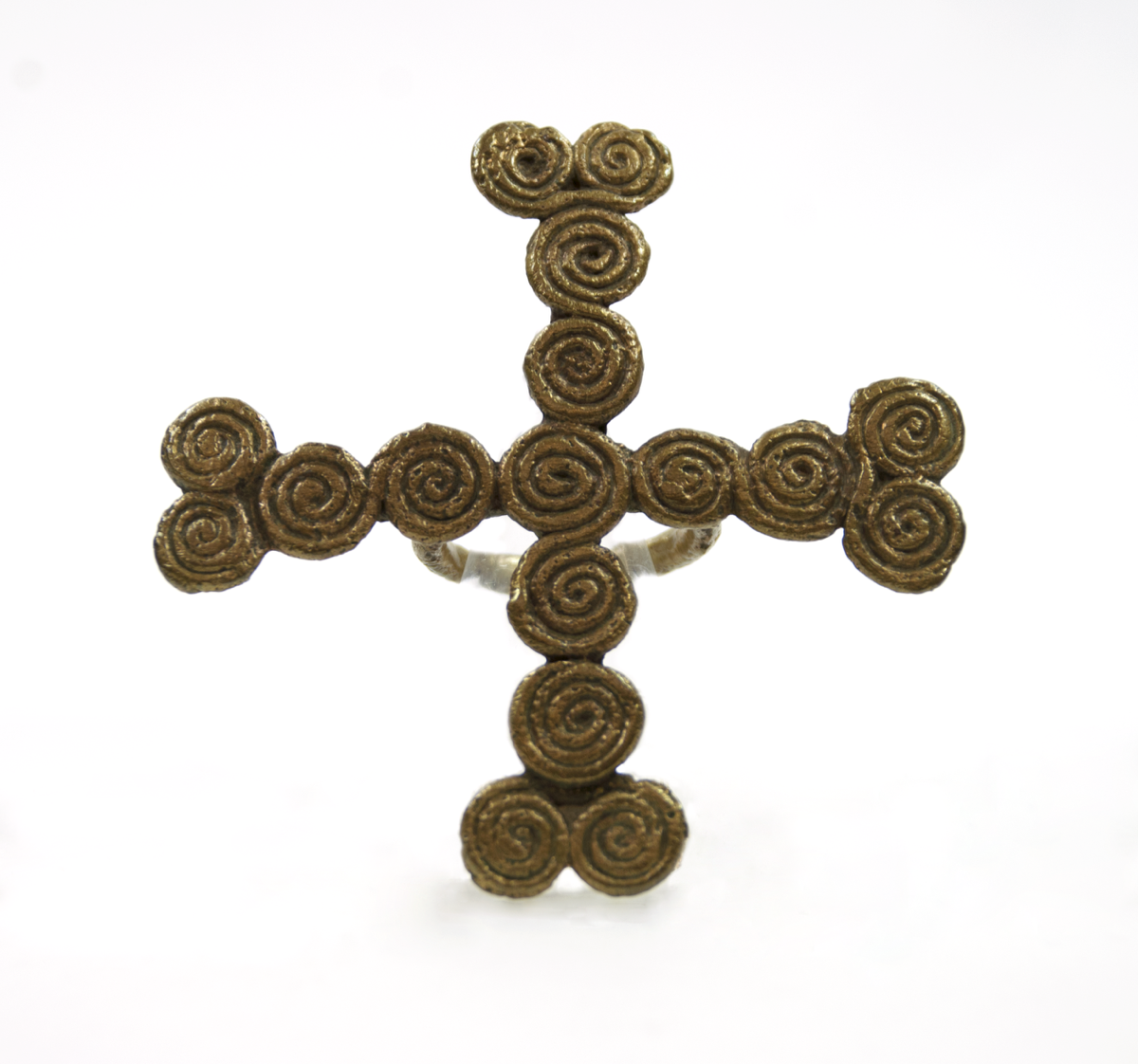 A brass ring with a cross formed of spirals, with two spirals at the top.