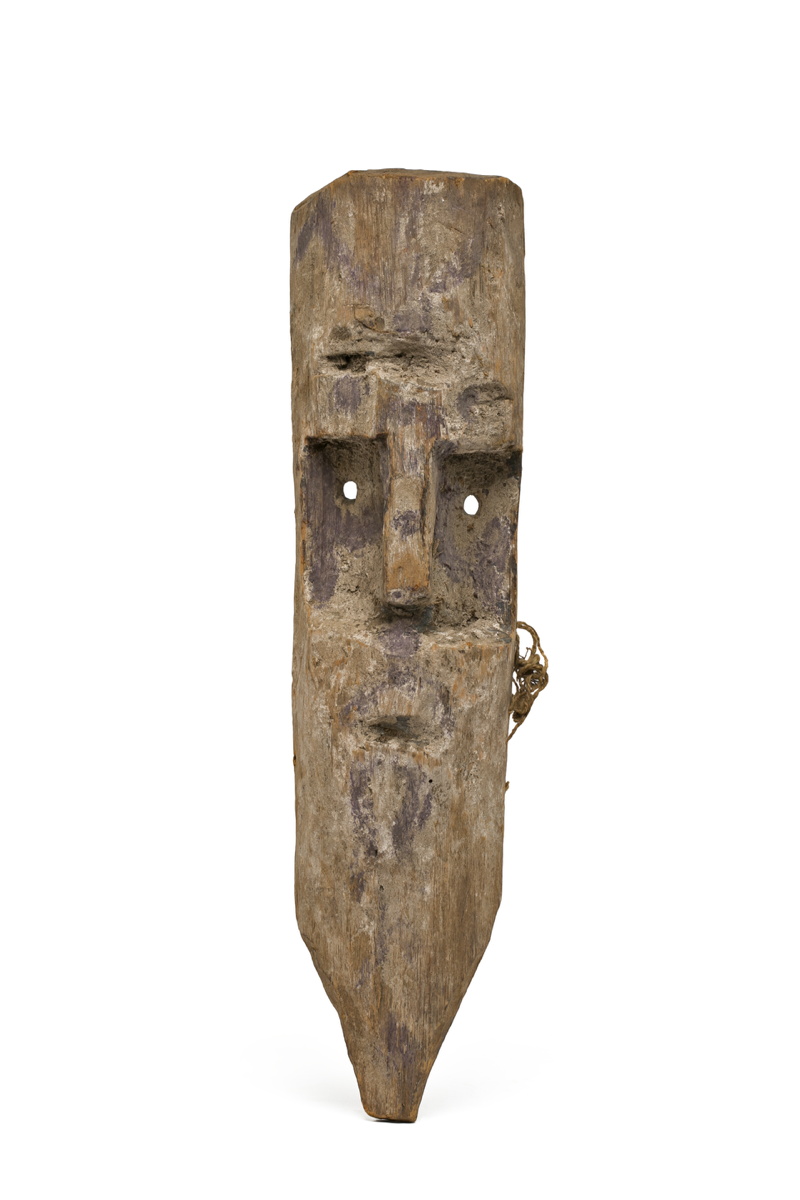  Roughly carved wooden face mask with elongated chin, and possible beard and moustache. The mask is very long and thin, with a small cap-like portion.