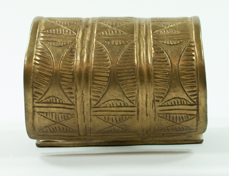 Wide, wrought brass bracelet with three strips of similar pattern.