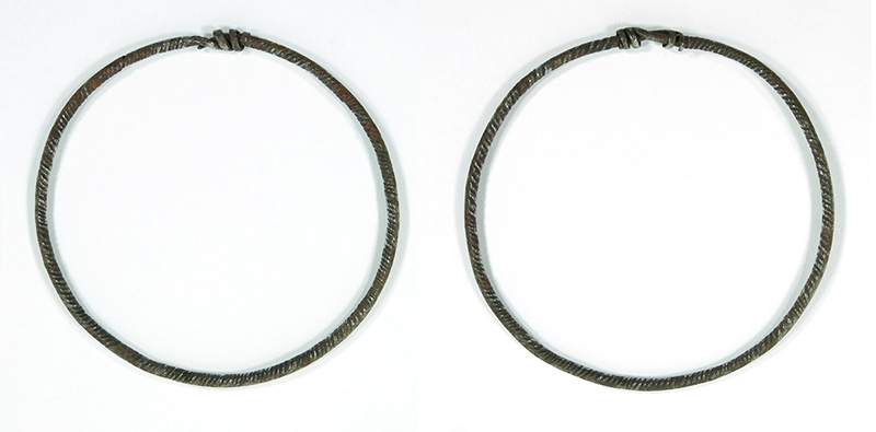Two thin bracelets with a twisted design.