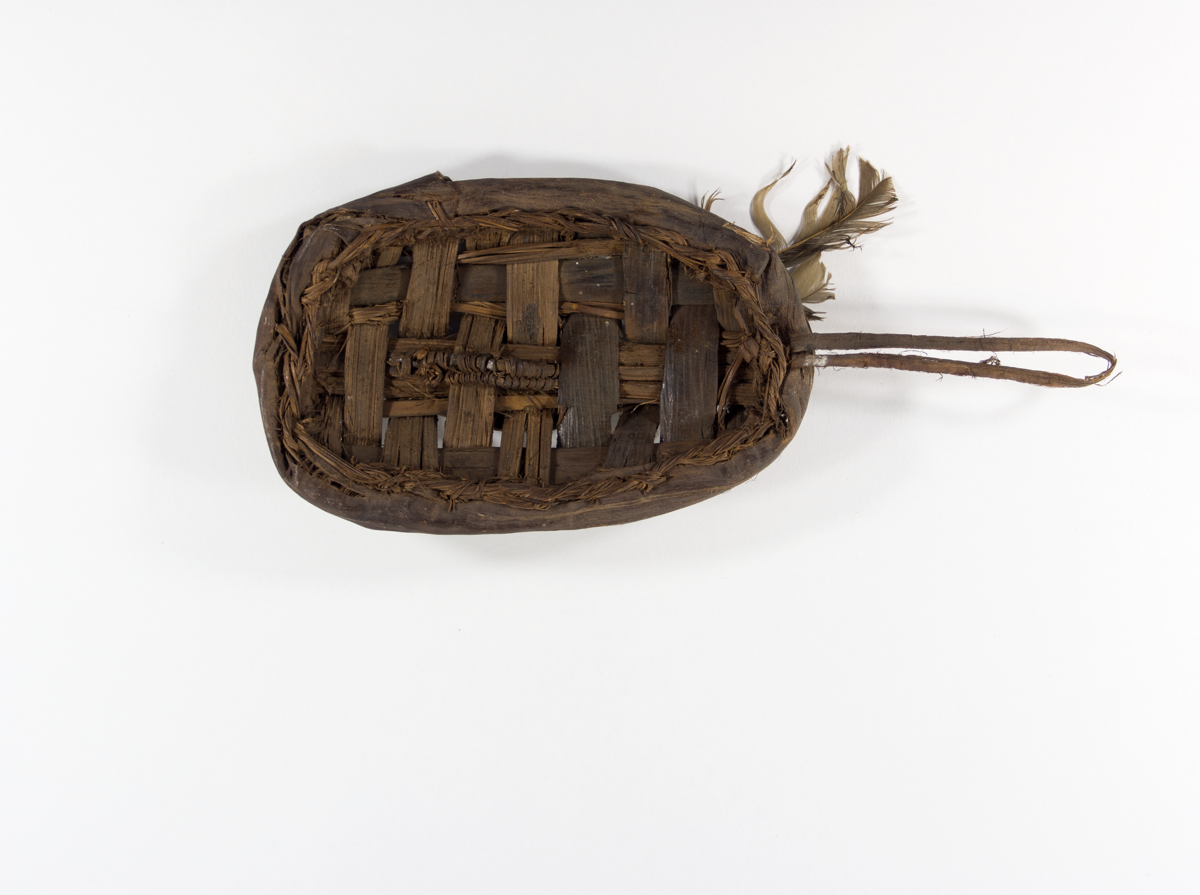 Miniature oval shield, made of chequer work of bark and decorated with a few feathers.