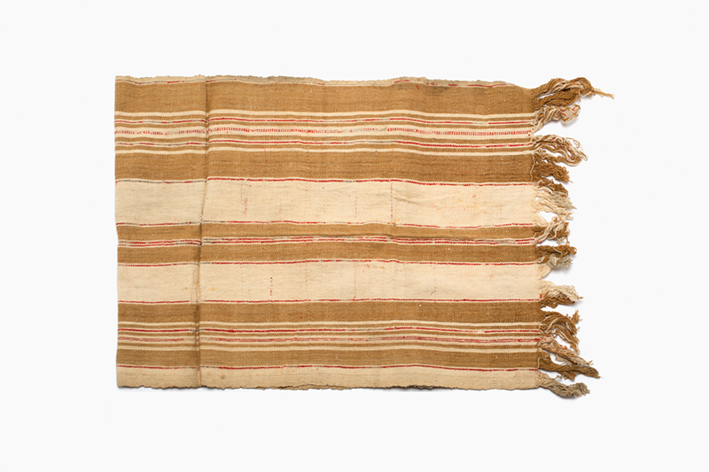 Brown, beige and red striped cloth with fringes on both short edges.