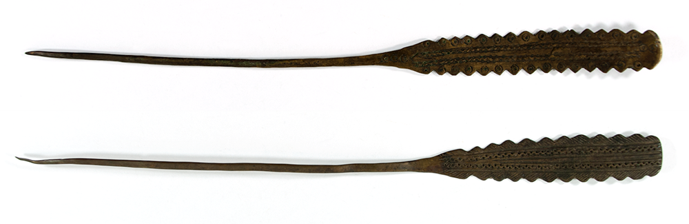 Two brass hairpins, both flat with jagged edges.