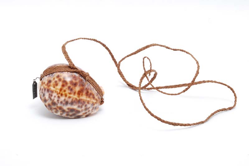 Rounded fish bait with brown speckled marking, tied in long brown twine.