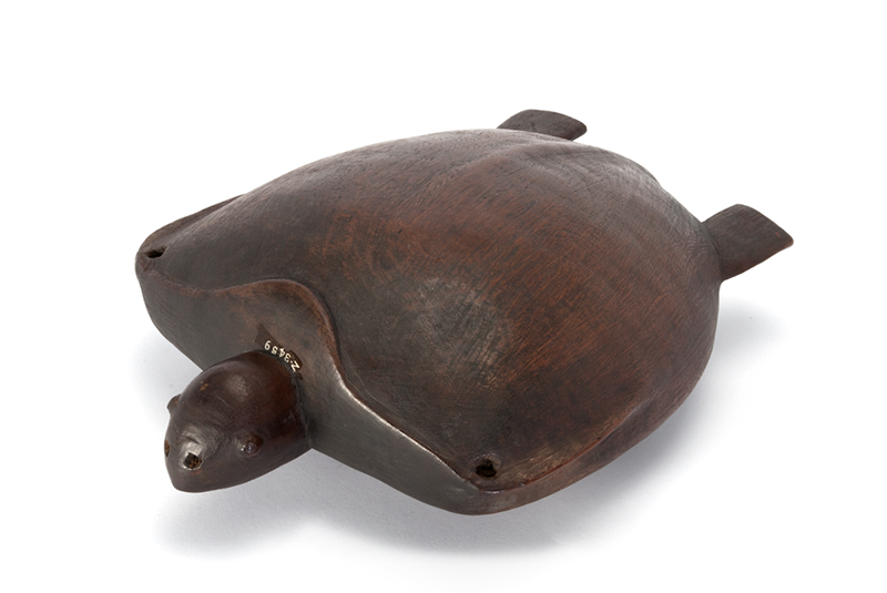 Large, flat bowl, face down, with feet and a head to indicate the shape of a turtle. 'Z 3459' written in white near the base of the turtle's neck.