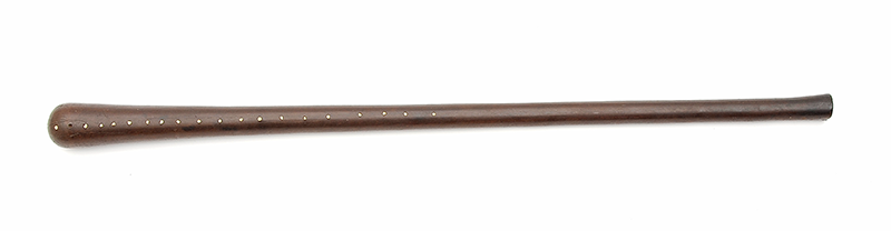 Dark wood club with a flared convex head. The upper part are inlaid with small shell and teeth pieces.