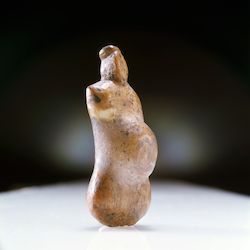 Small, ivory pendant in the form of a pregnant woman, from Ryder Island, Arctic. MAA 1935.1073. Photography by Gwil Owen. Small, ivory pendant in the form of a pregnant woman, from Ryder Island, Arctic