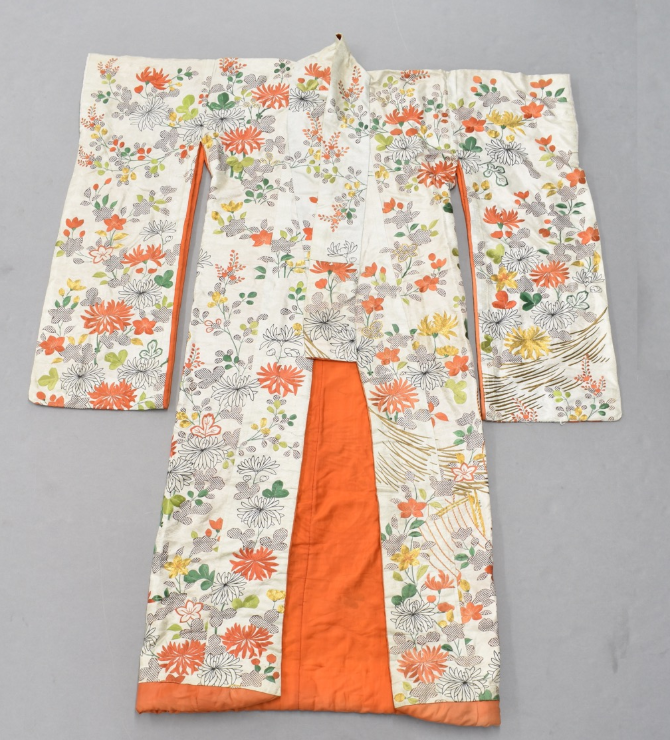 A white silk robe woven with a geometric and floral design.