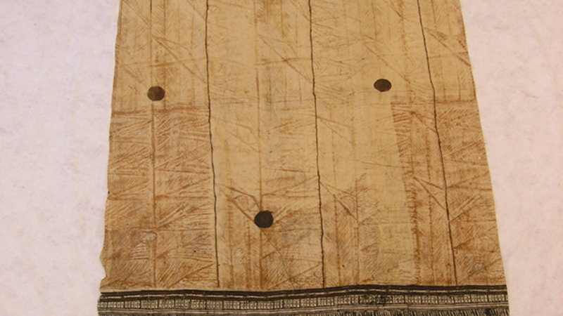 Barkcloth with intricate black patterned detailing on the near edge.