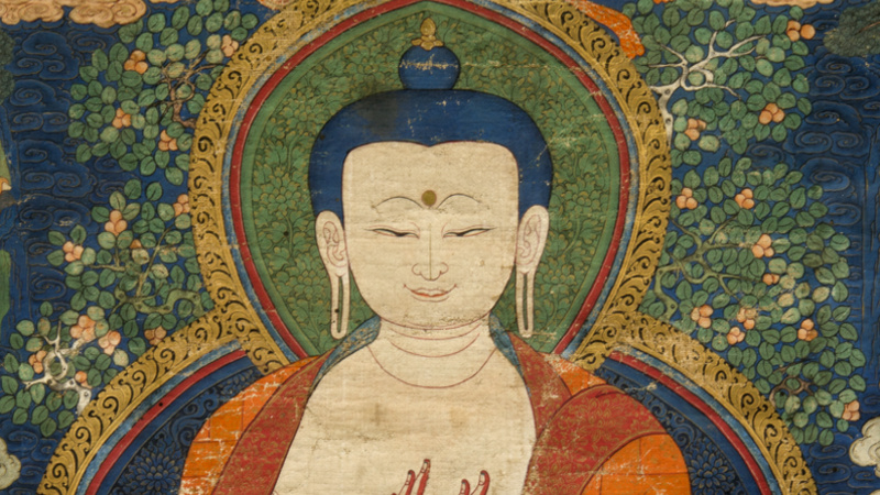The Buddha wears a patchwork saffron robe and is seated in the diamond position.