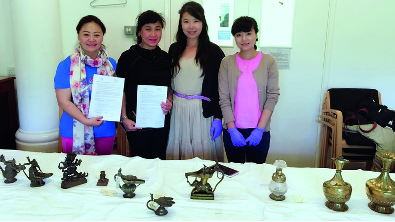 A photo of women and museum objects