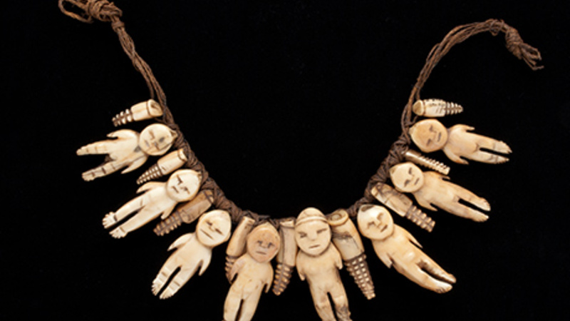 Necklace of eight ivory figures, interspersed with smaller decorative 'teeth' type figures.
