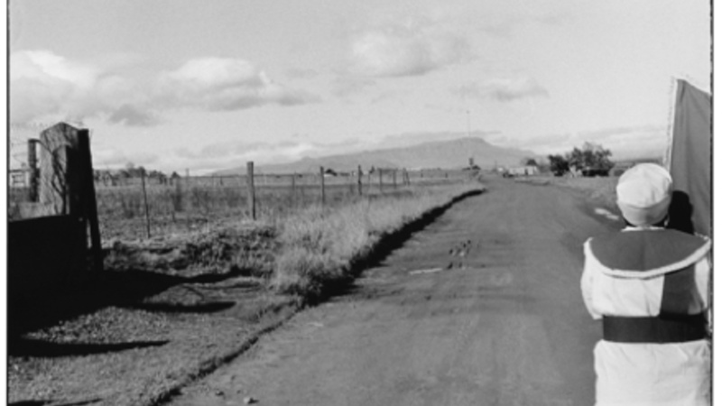 Black and white photo of a road and a person