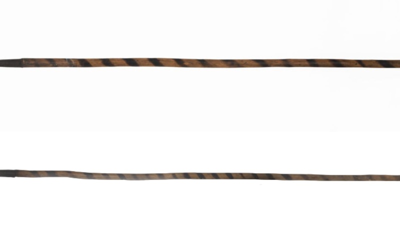 Two spears with triangular blades which have slightly convex edges and two barbs. The wooden shafts are decorated with spiral bands of dark colour.