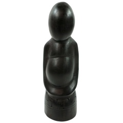 A polished ebony wood figure of a heavily pregnant woman with her hands clasped under her stomach.