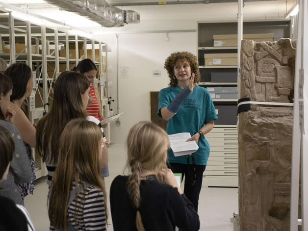 A member of the museum's staff gives a tour of the off-site store to a group of families.