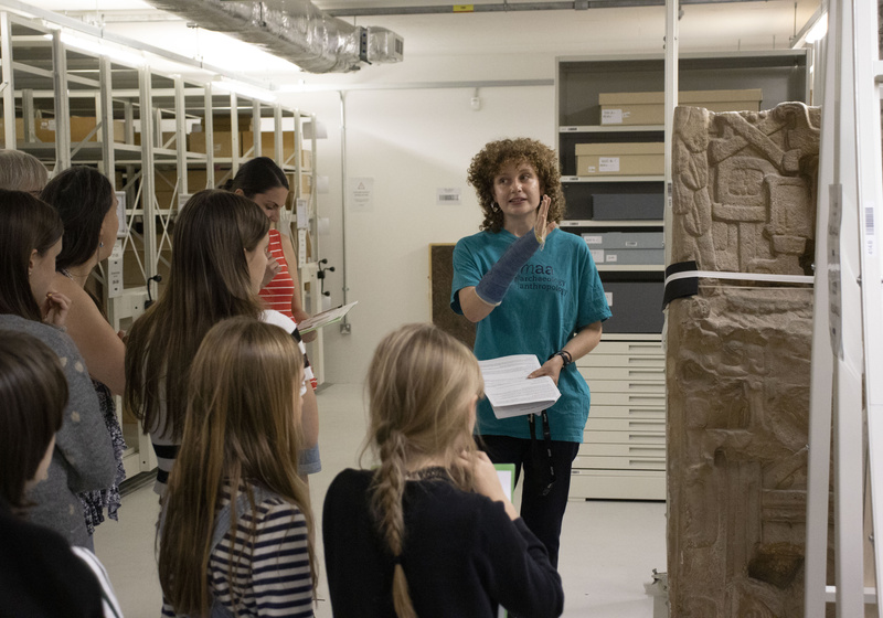 A member of the museum's staff gives a tour of the off-site store to a group of families.