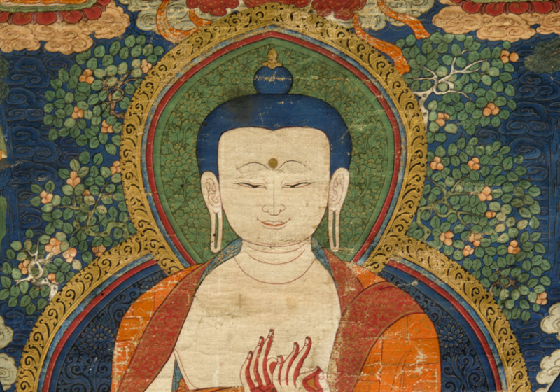 The Buddha wears a patchwork saffron robe and is seated in the diamond position.