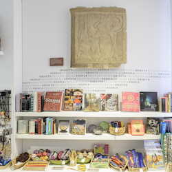 Colour photograph of books on a bookshelf in the MAA shop