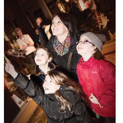 A colour photograph of a family visiting the MAA