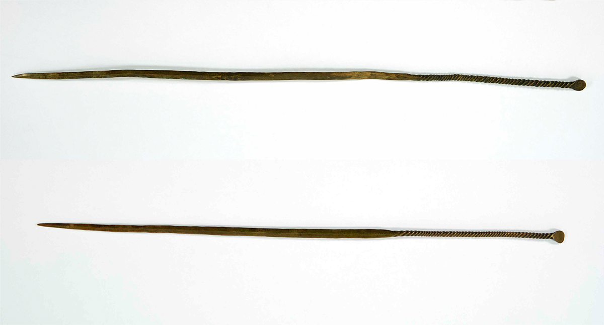 Two long brass hair pins.