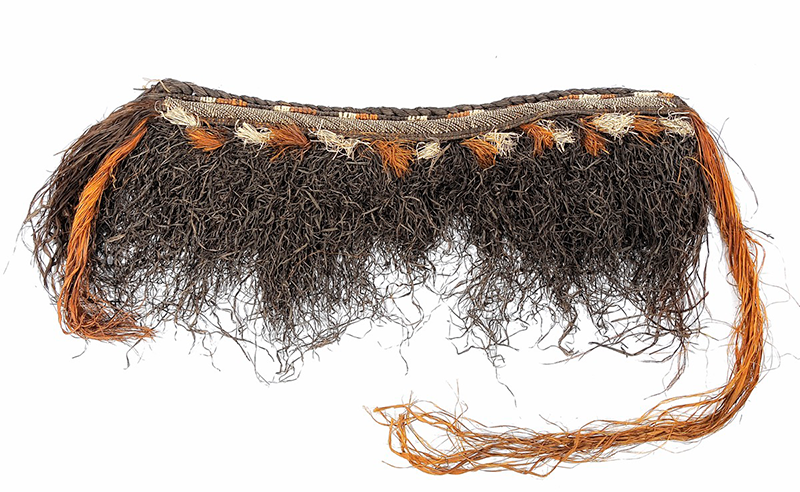  A liku, a dress or skirt of fibre, straw colour and crinkly brown.