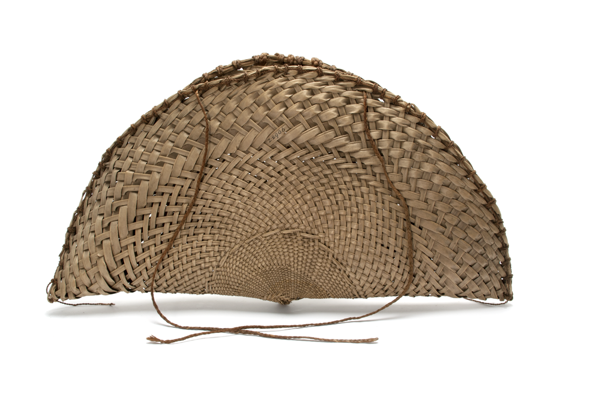 Large semi-circular fishing basket (noke) formed of a circle of coconut palm leaf basketry folded in two. The edges are tied on both side with twisted hibiscus cord.