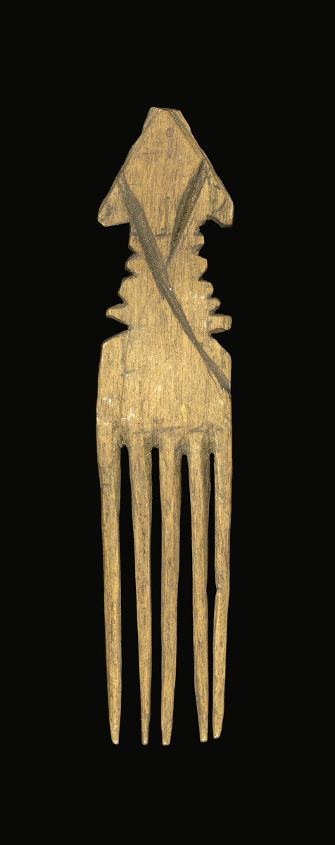 A comb carved from wood with five cylindrical and tapering prongs. The handle has notches cut-out on each side forming serrated edges, the top is triangular shaped.
