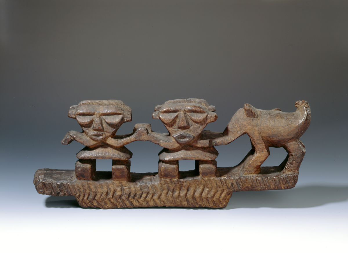 Wooden sculpture of two humans and an animal likely from Tahiti