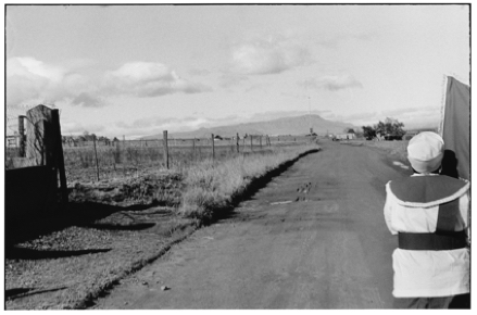 Black and white photo of a road and a person