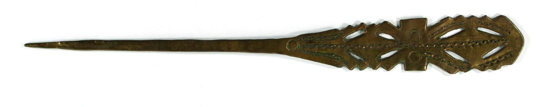 A brass hairpin with the design of the top segment split into three sections; oval shaped with jagged edges and negative spaces inside, an oblong with two circles, and a similar design to the first leading into the hairpin point/taper.