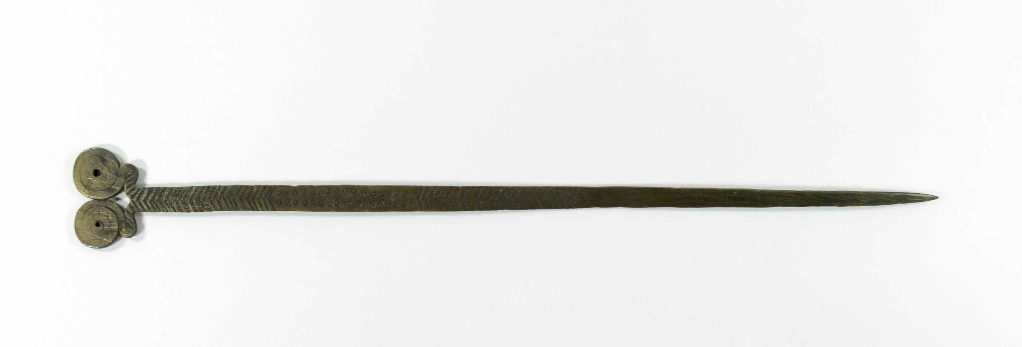Brass hairpin with two spirals forming the head of the pin.