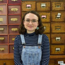 A colour photograph of Emily Shorter, Collections Assistant for the MAA Stores Move